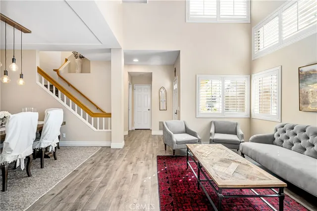 a living room with furniture and a hard wood floor