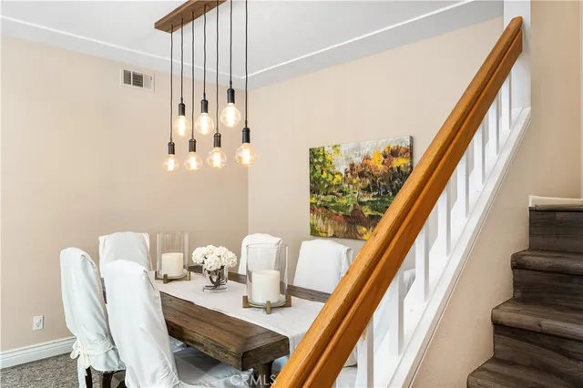 a view of a dining room with furniture and a floor to ceiling window