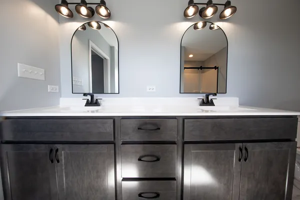 a spacious bathroom with a granite countertop sink a large mirror a and a window