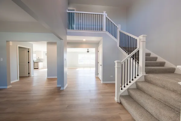 a view of entryway and hall with wooden floor