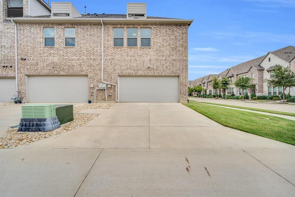 1498 Weston Road Dallas, TX 75234 - Photo 23 of 24 Brick facade home featuring a two-car garage, concrete driveway, and second-story windows