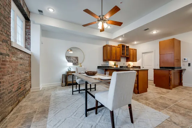 a view of a kitchen with kitchen island dining table and stainless steel appliances