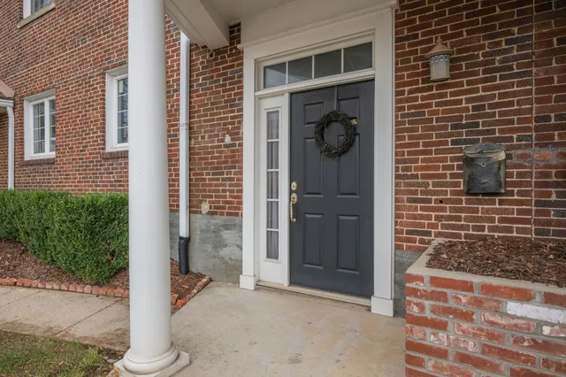 a view of a door and brick walls