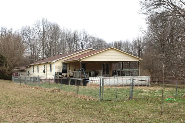 a backyard of a house with wooden fence