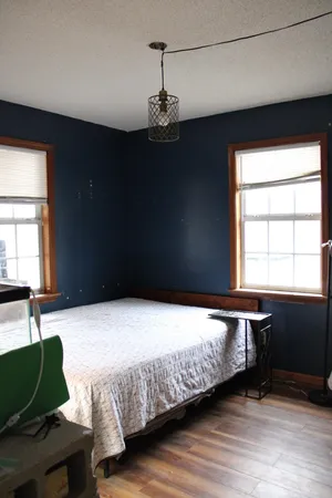 a bedroom with a bed and window