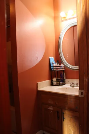 a bathroom with a sink vanity mirror and toilet