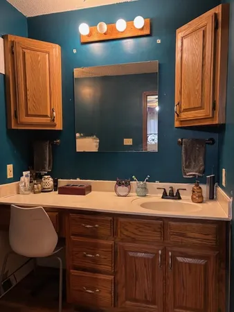 a kitchen with a sink cabinets and a wooden floor