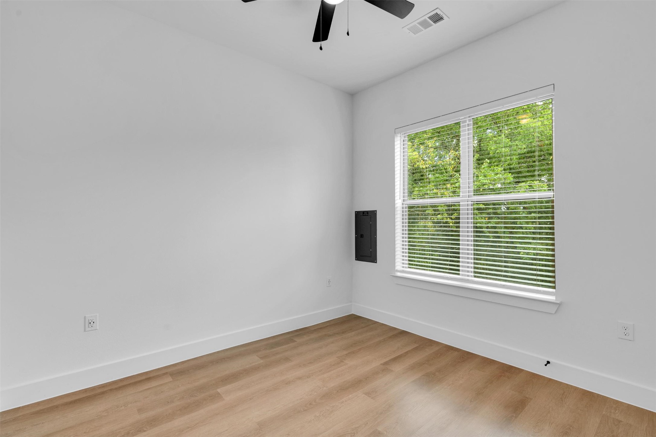 1427 B Soccer Drive Little Elm, TX 75068 - Photo 14 of 31 a view of an empty room with a window and wooden floor