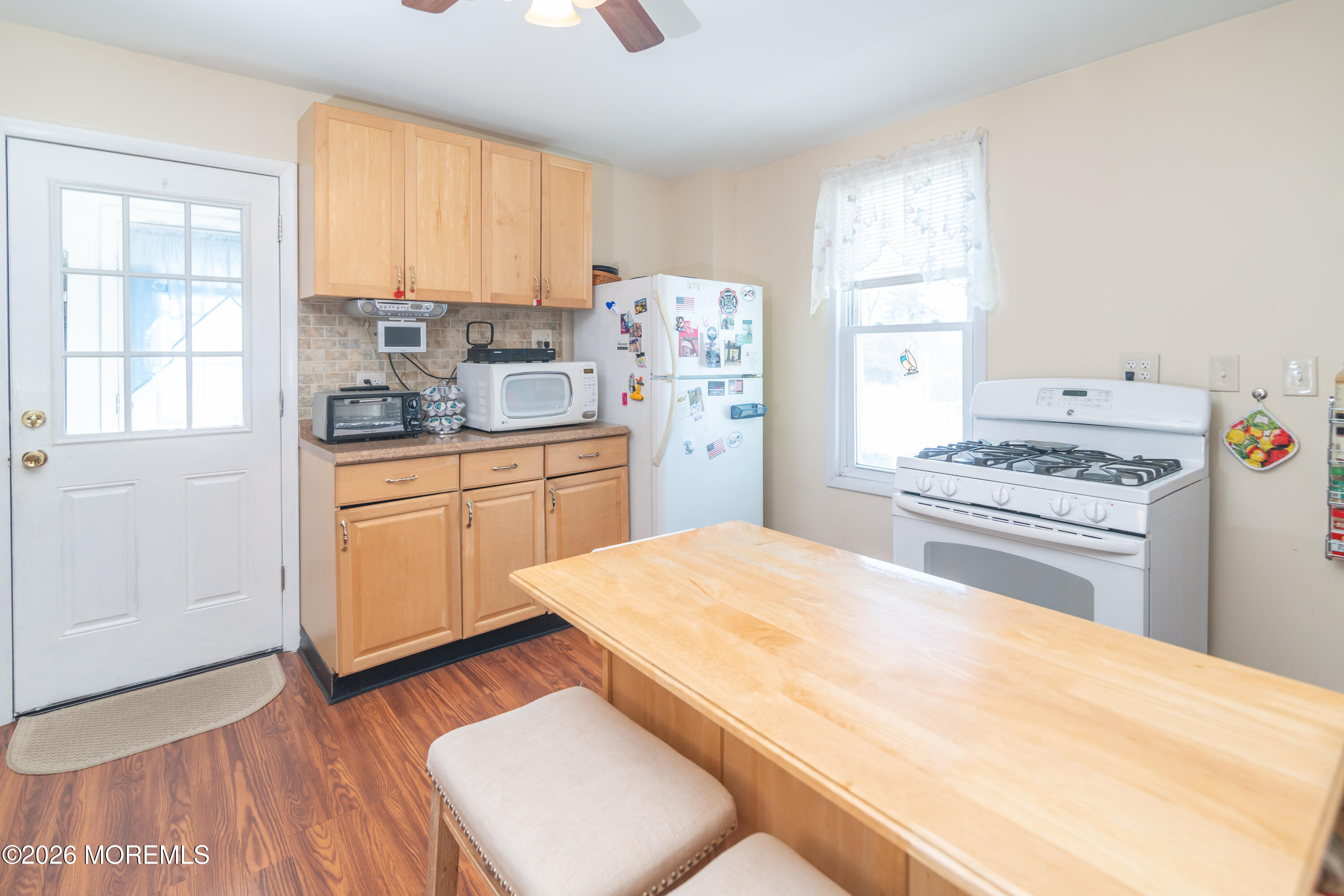 55 Lower Main Street Aberdeen, NJ 07747 - Photo 11 of 28 a kitchen with a stove a sink dishwasher and a refrigerator with wooden floor