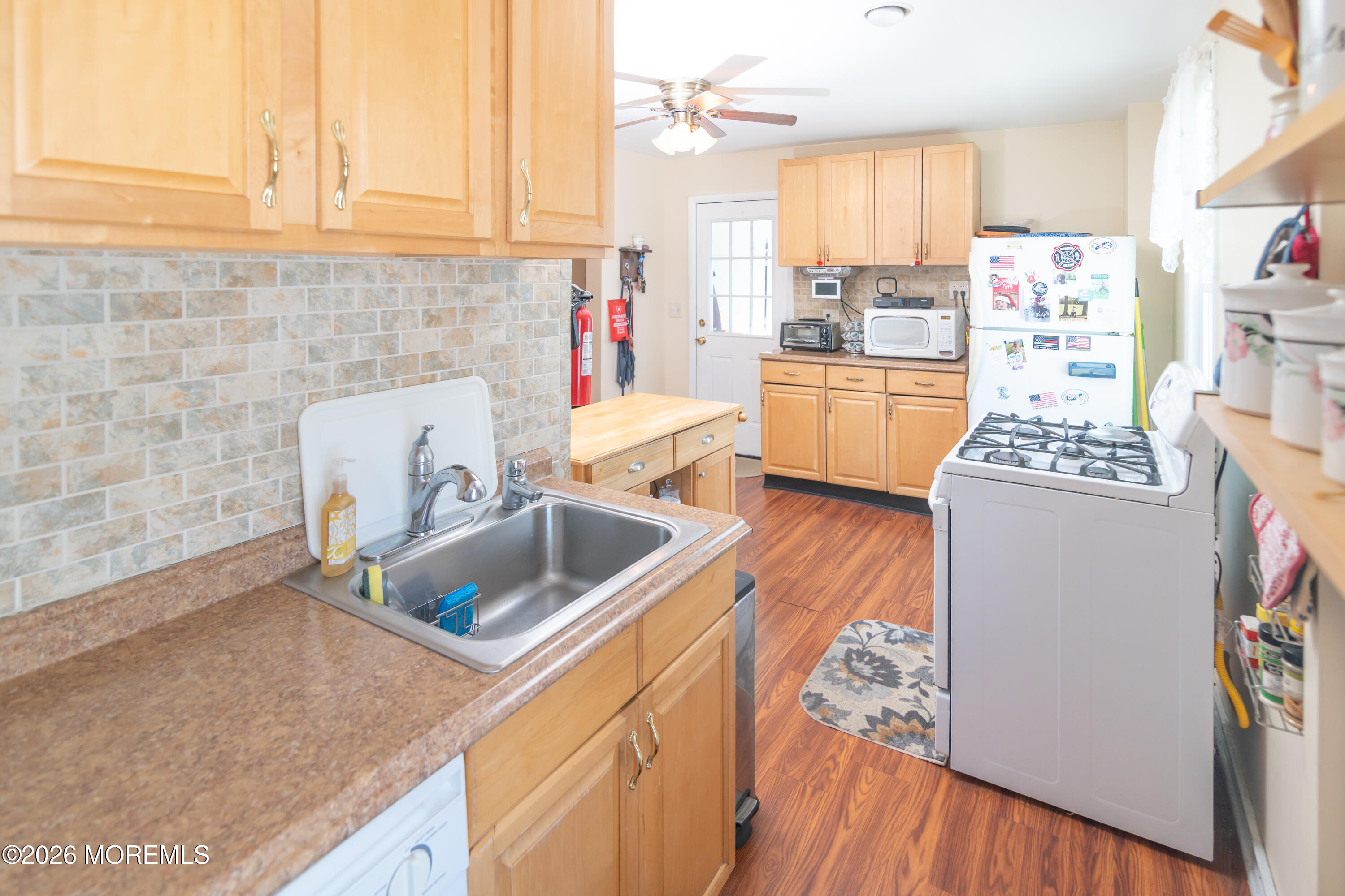 55 Lower Main Street Aberdeen, NJ 07747 - Photo 13 of 28 a kitchen with stainless steel appliances granite countertop a sink stove and refrigerator