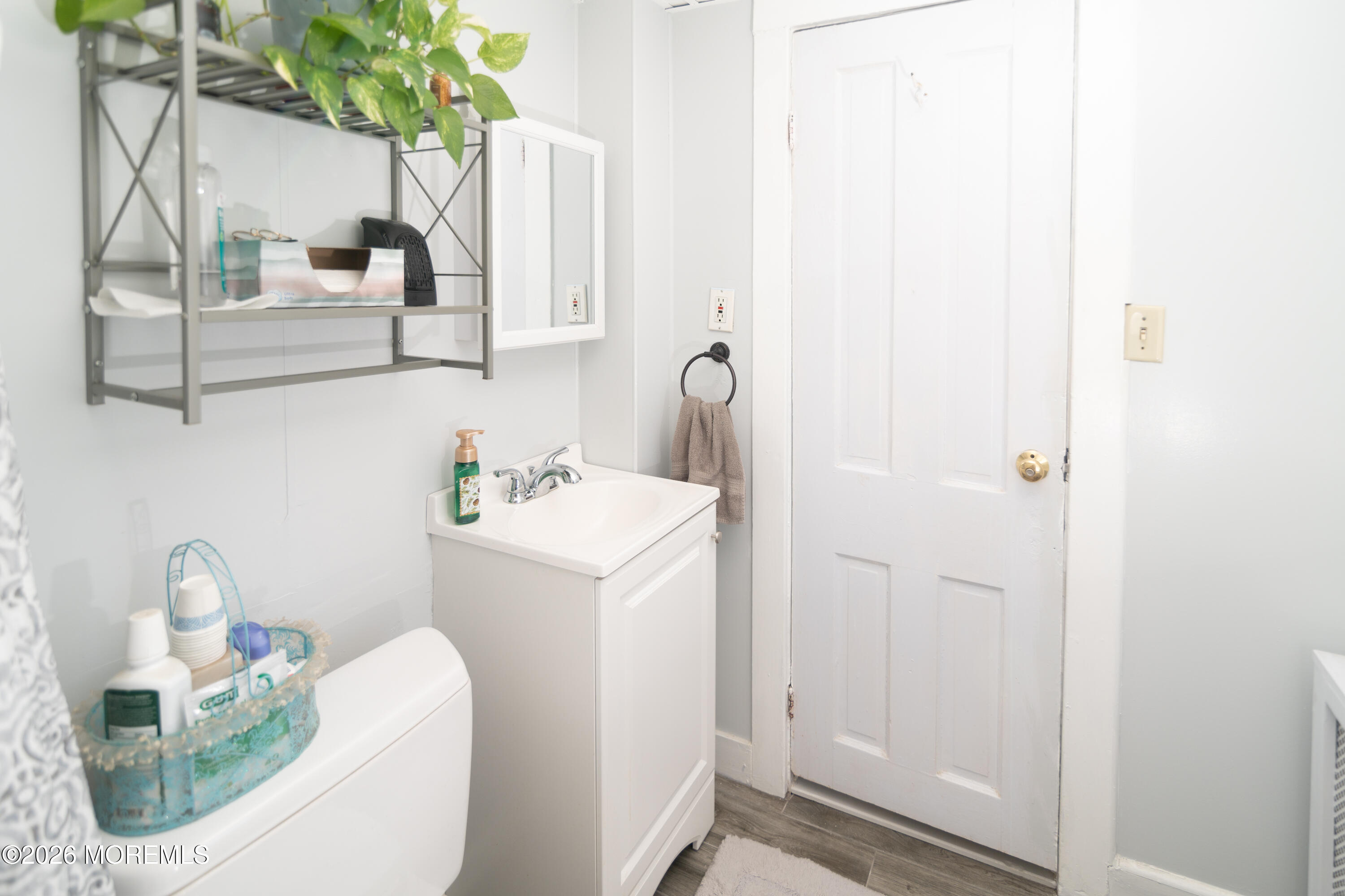 55 Lower Main Street Aberdeen, NJ 07747 - Photo 26 of 28 a bathroom with a sink a toilet and a mirror