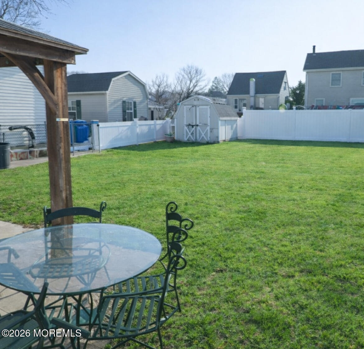 55 Lower Main Street Aberdeen, NJ 07747 - Photo 27 of 28 a backyard of a house with table and chairs