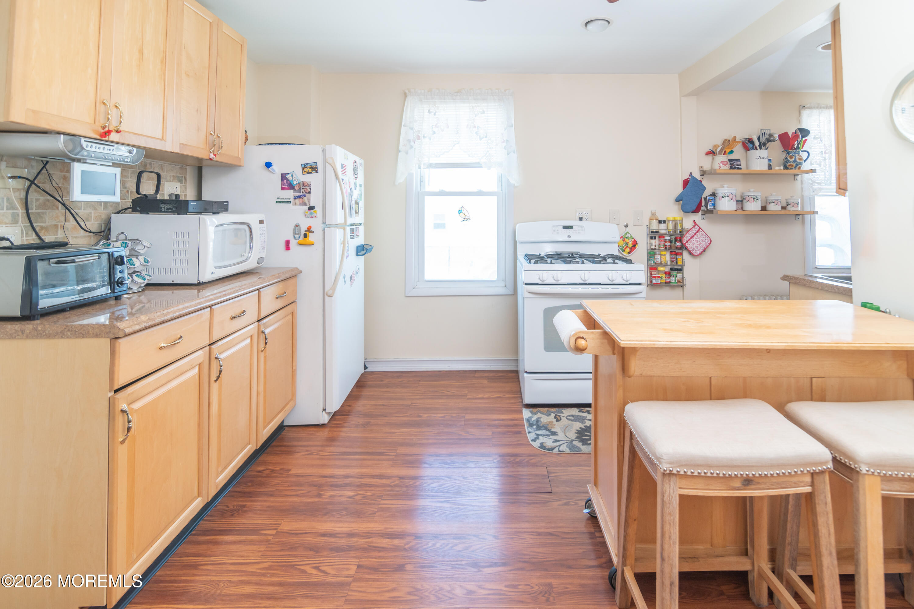 55 Lower Main Street Aberdeen, NJ 07747 - Photo 10 of 28 a kitchen with wooden cabinets and center island