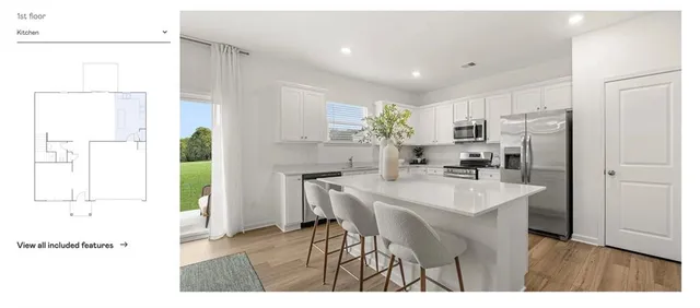 a kitchen with furniture and a potted plant