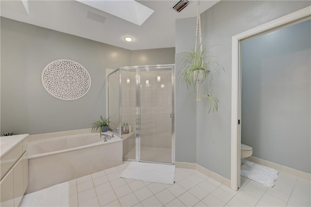 8171 Hampton Wood Drive Boca Raton, FL 33433 - Photo 19 of 56 a spacious bathroom with a shower a bathtub and a shower