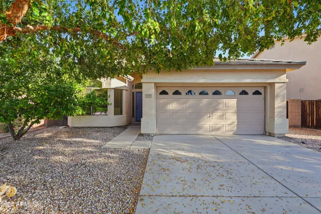 a front view of a house with a yard and a garage