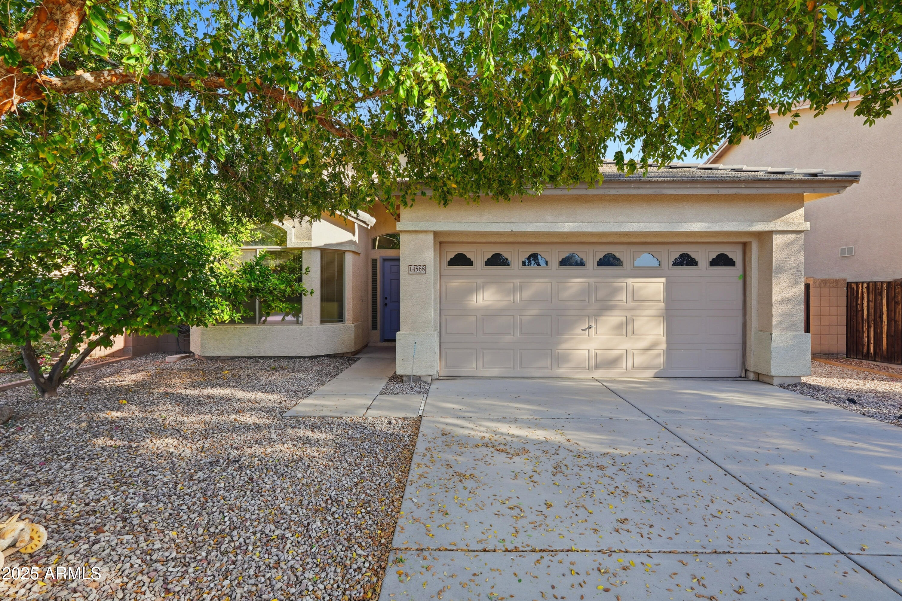 a front view of a house with a yard and a garage
