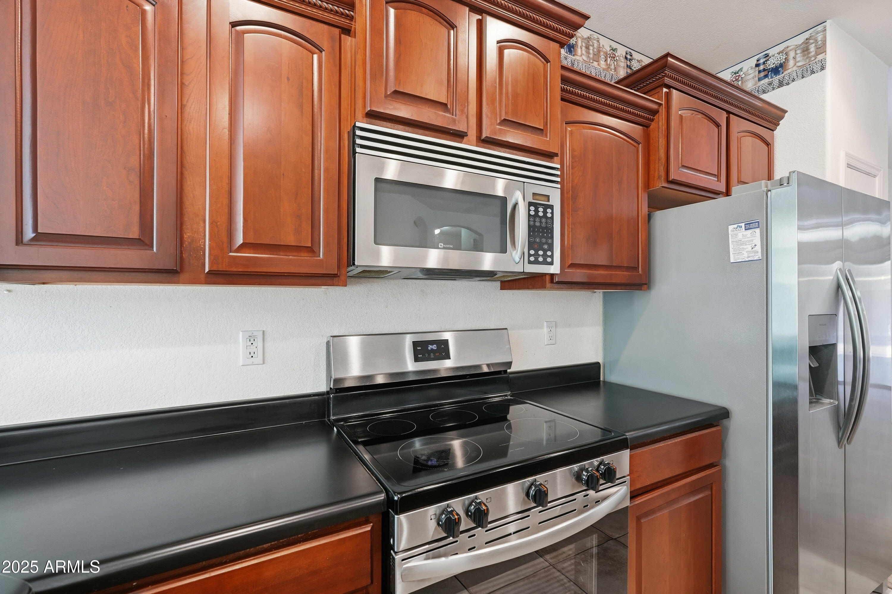 14568 West Crocus Drive Surprise, AZ 85379 - Photo 13 of 36 a kitchen with stainless steel appliances granite countertop a stove and a microwave