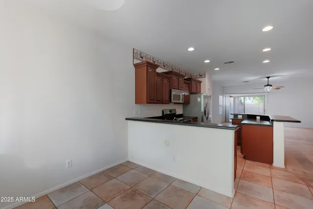a kitchen with stainless steel appliances a refrigerator sink and microwave