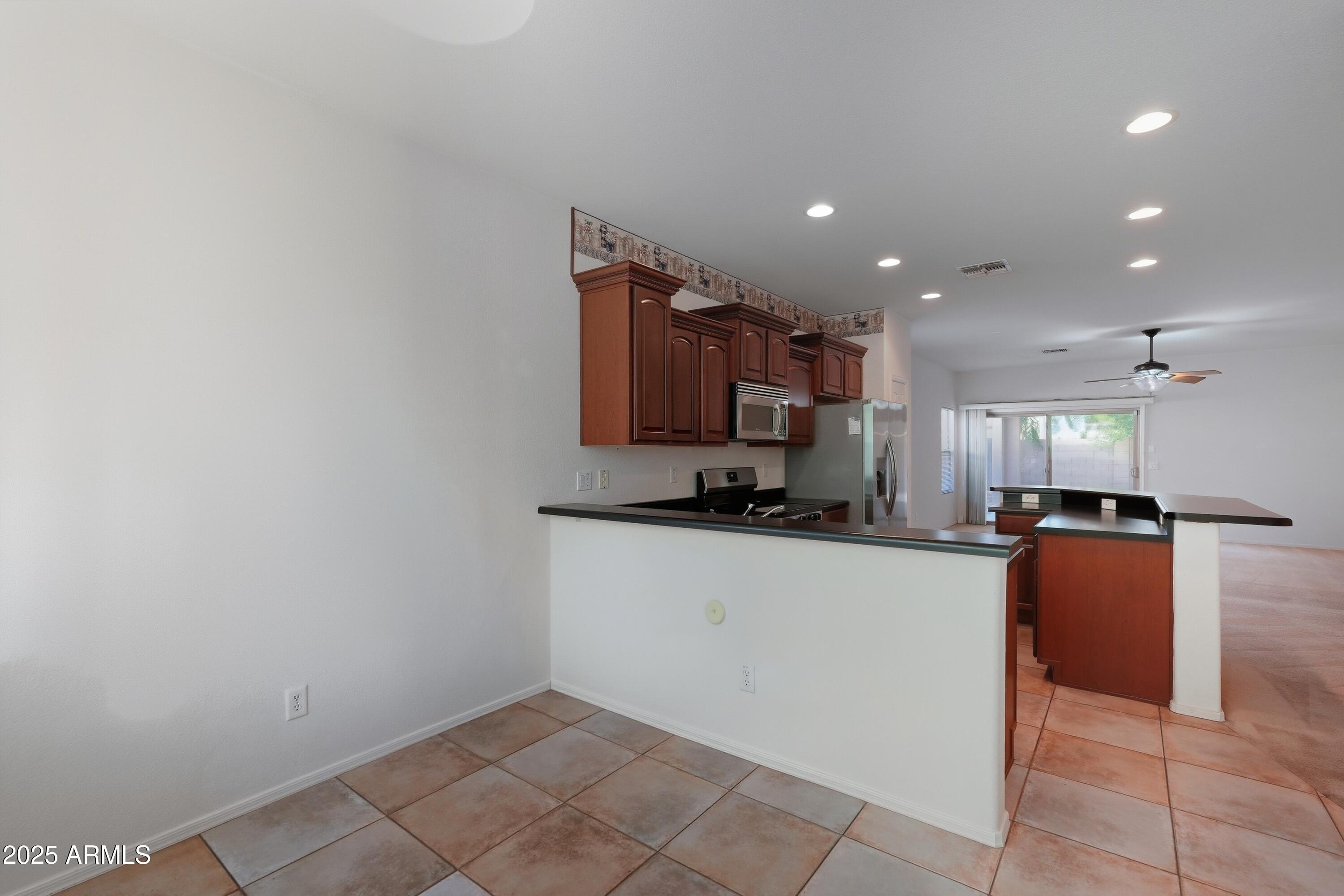 14568 West Crocus Drive Surprise, AZ 85379 - Photo 14 of 36 a kitchen with stainless steel appliances a refrigerator sink and microwave