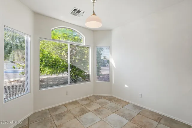 an empty room with windows and outdoor view