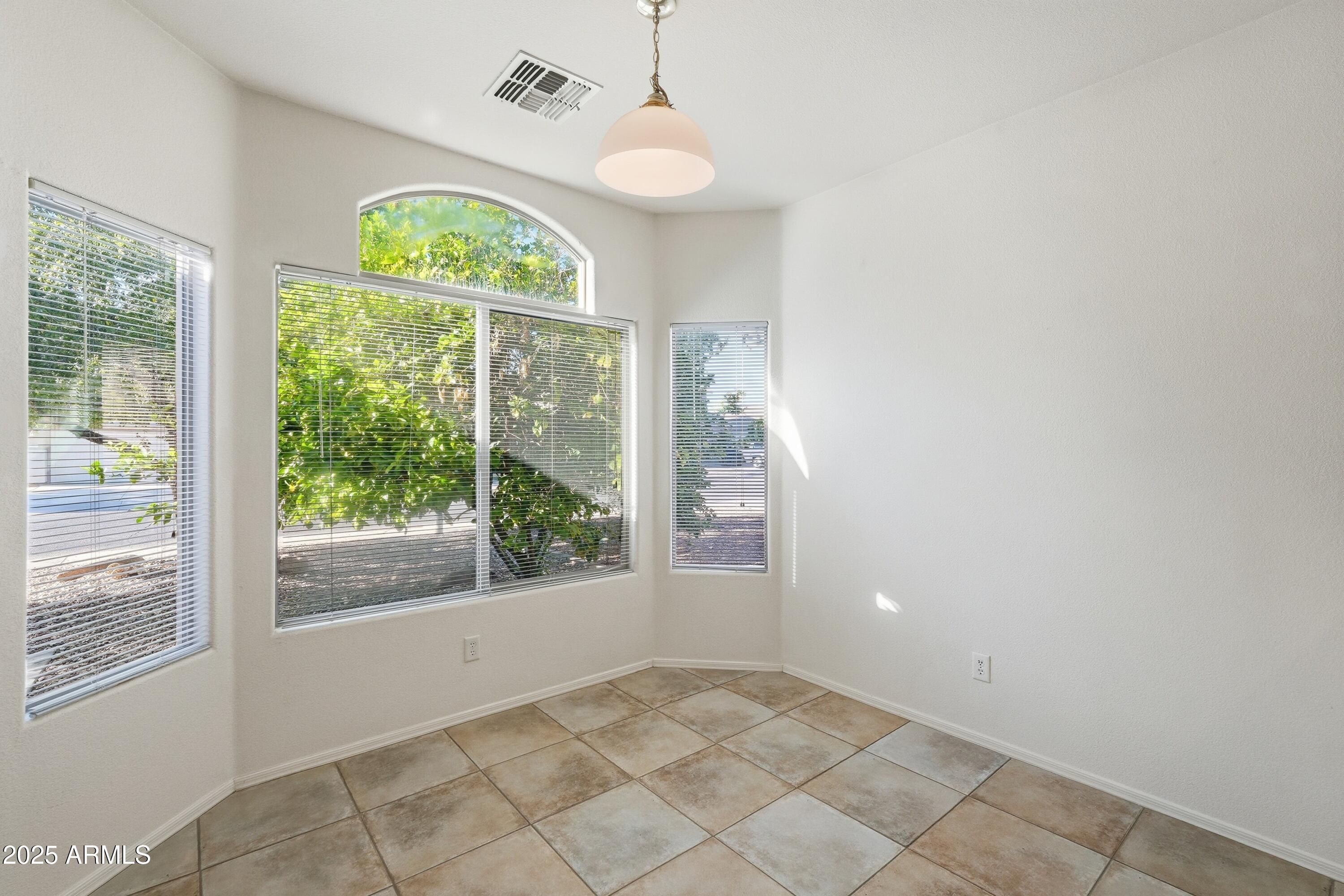 14568 West Crocus Drive Surprise, AZ 85379 - Photo 15 of 36 an empty room with windows and outdoor view
