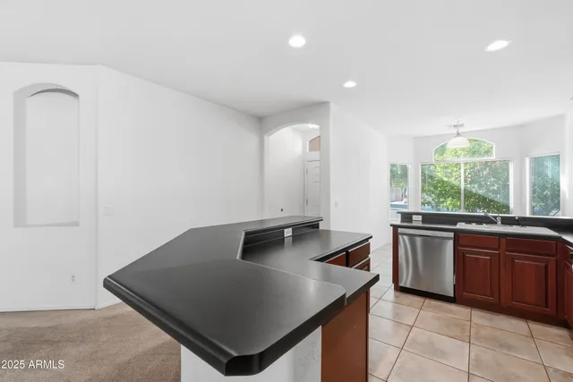 a kitchen with stainless steel appliances granite countertop a sink and a stove