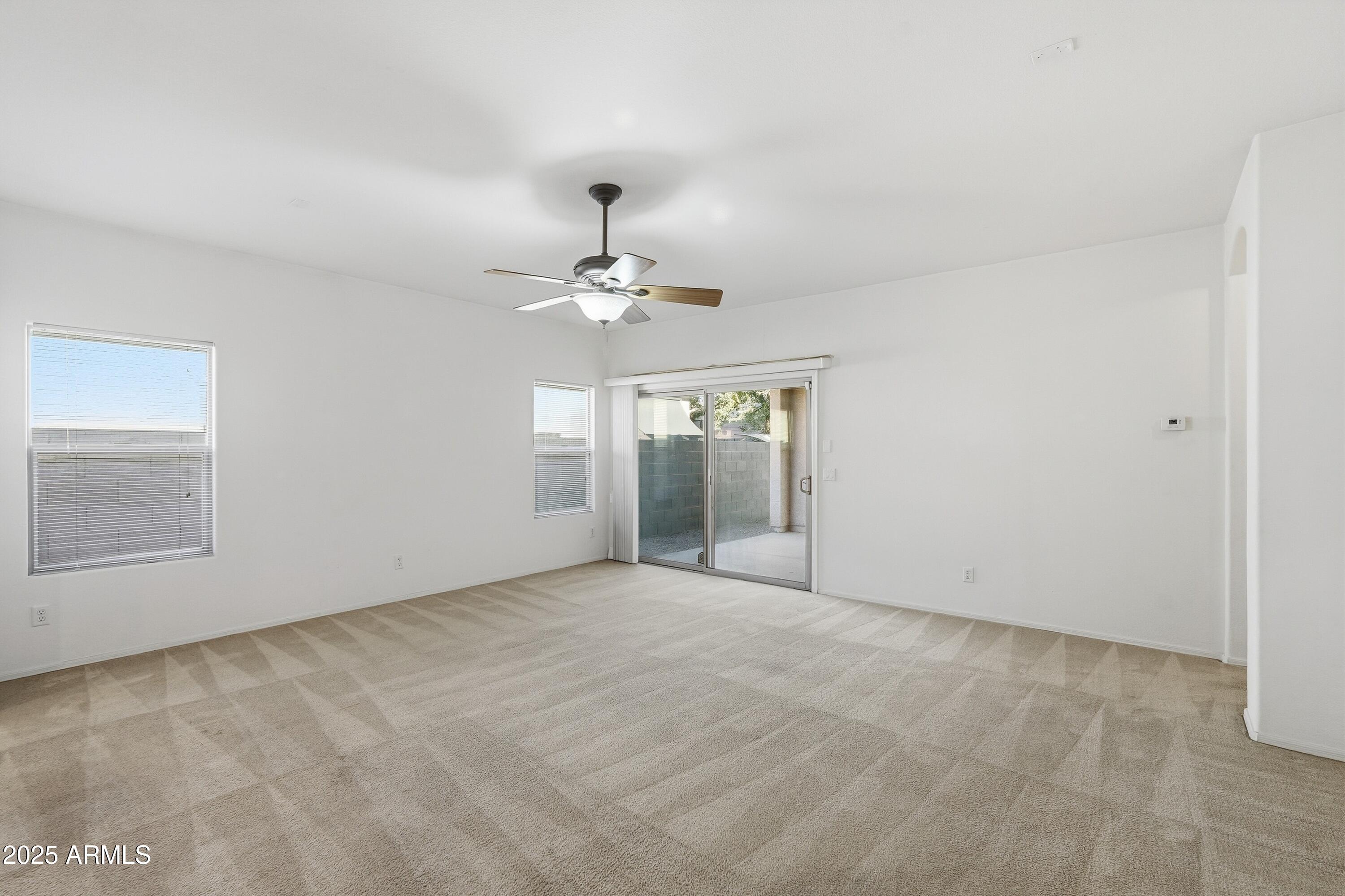 14568 West Crocus Drive Surprise, AZ 85379 - Photo 17 of 36 a view of an empty room with a chandelier fan