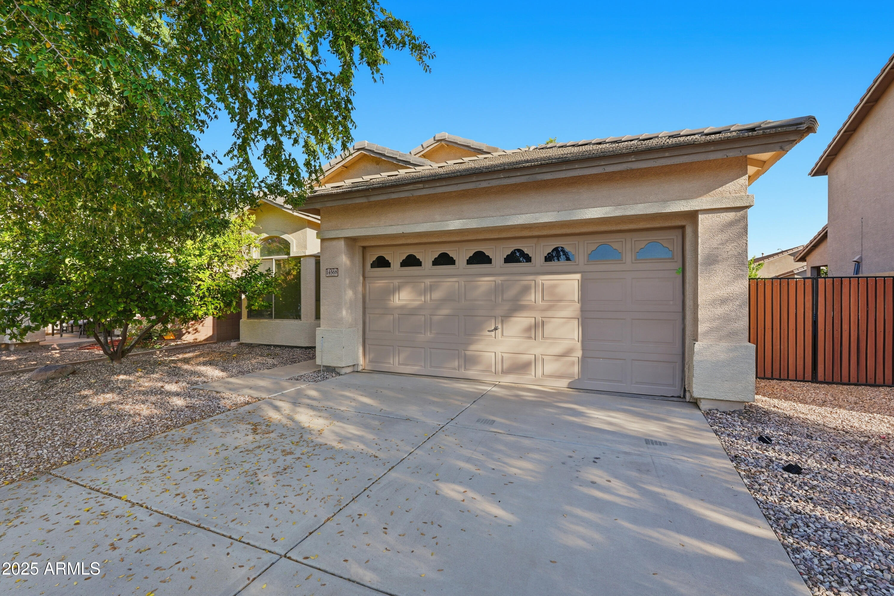 14568 West Crocus Drive Surprise, AZ 85379 - Photo 2 of 36 a front view of a house with a garage