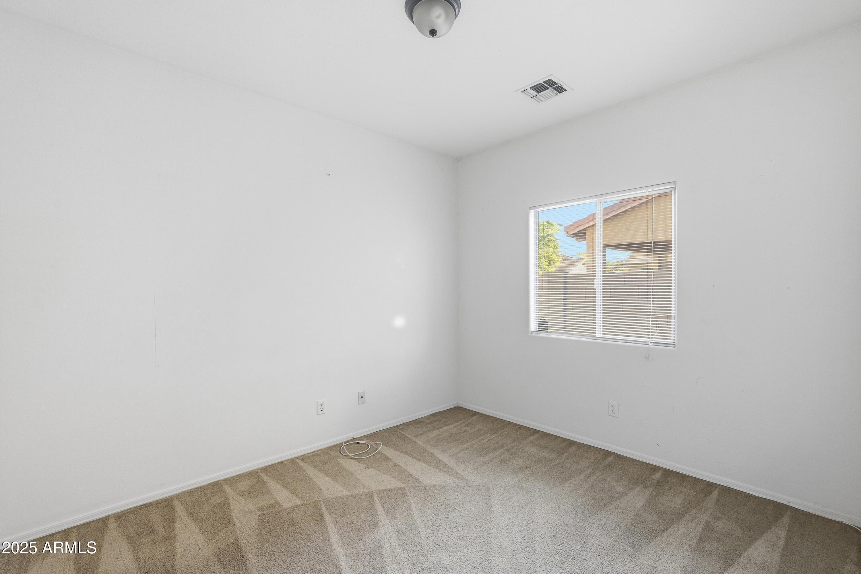 14568 West Crocus Drive Surprise, AZ 85379 - Photo 25 of 36 a view of an empty room with a window
