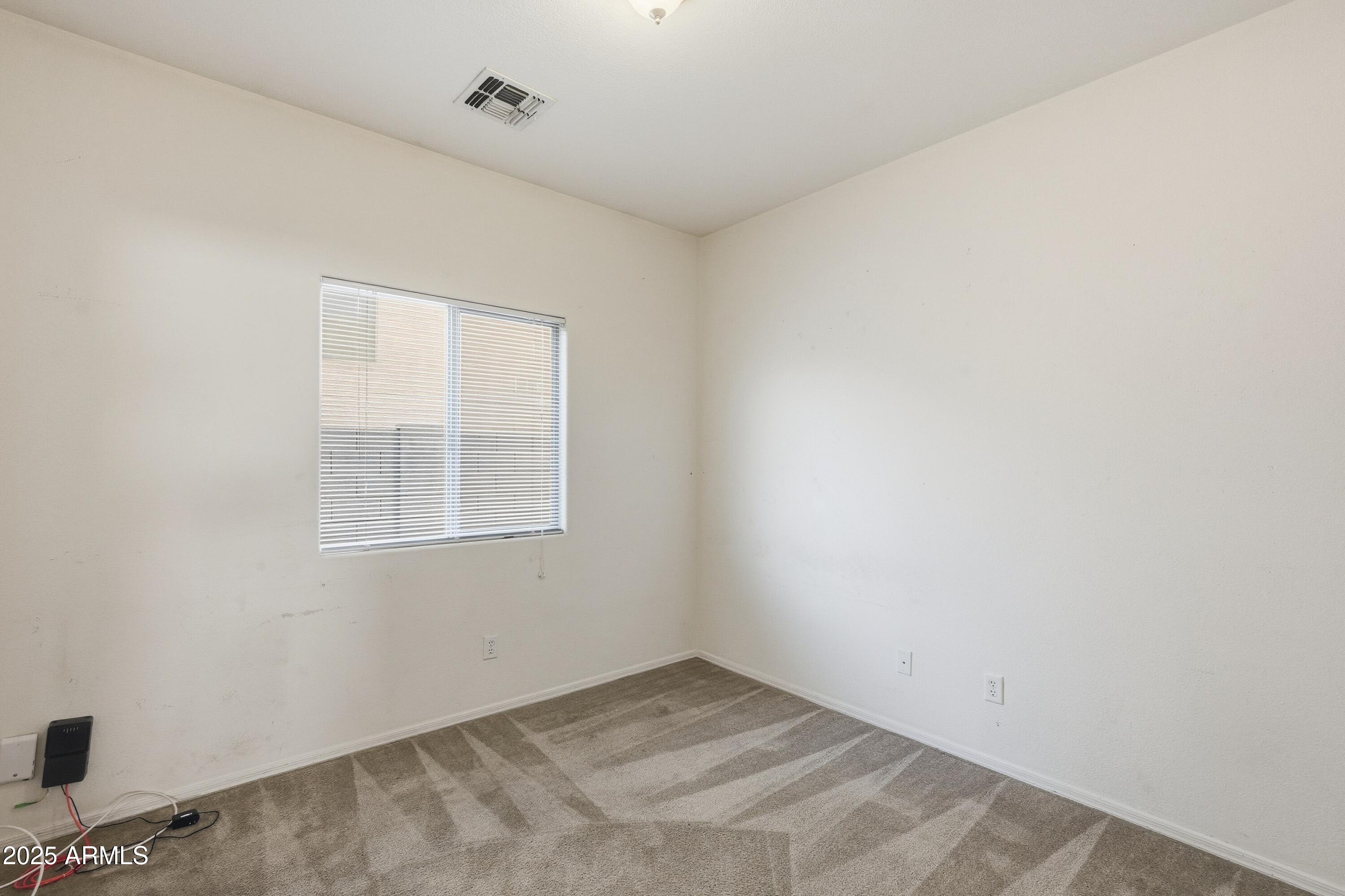 14568 West Crocus Drive Surprise, AZ 85379 - Photo 28 of 36 an empty room with a window