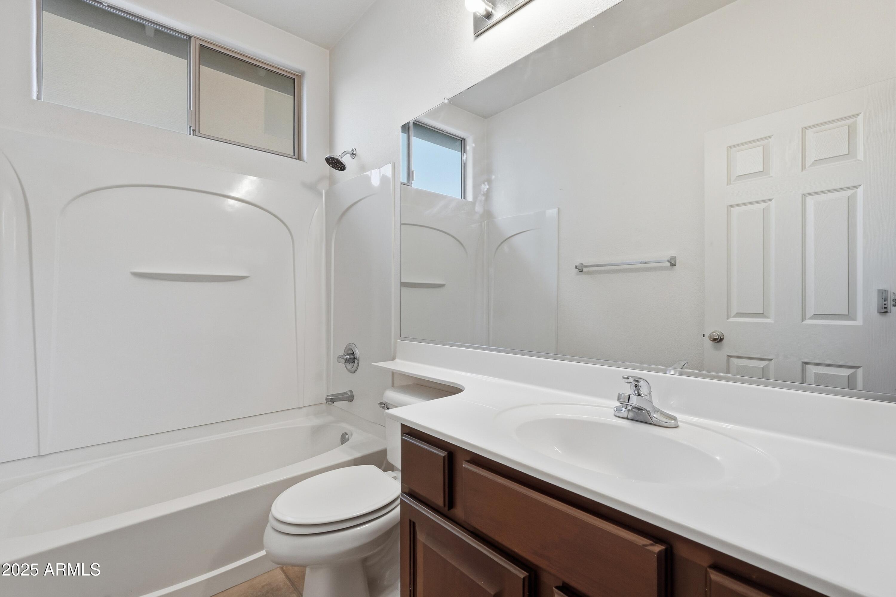 14568 West Crocus Drive Surprise, AZ 85379 - Photo 32 of 36 a bathroom with a sink a toilet and a mirror