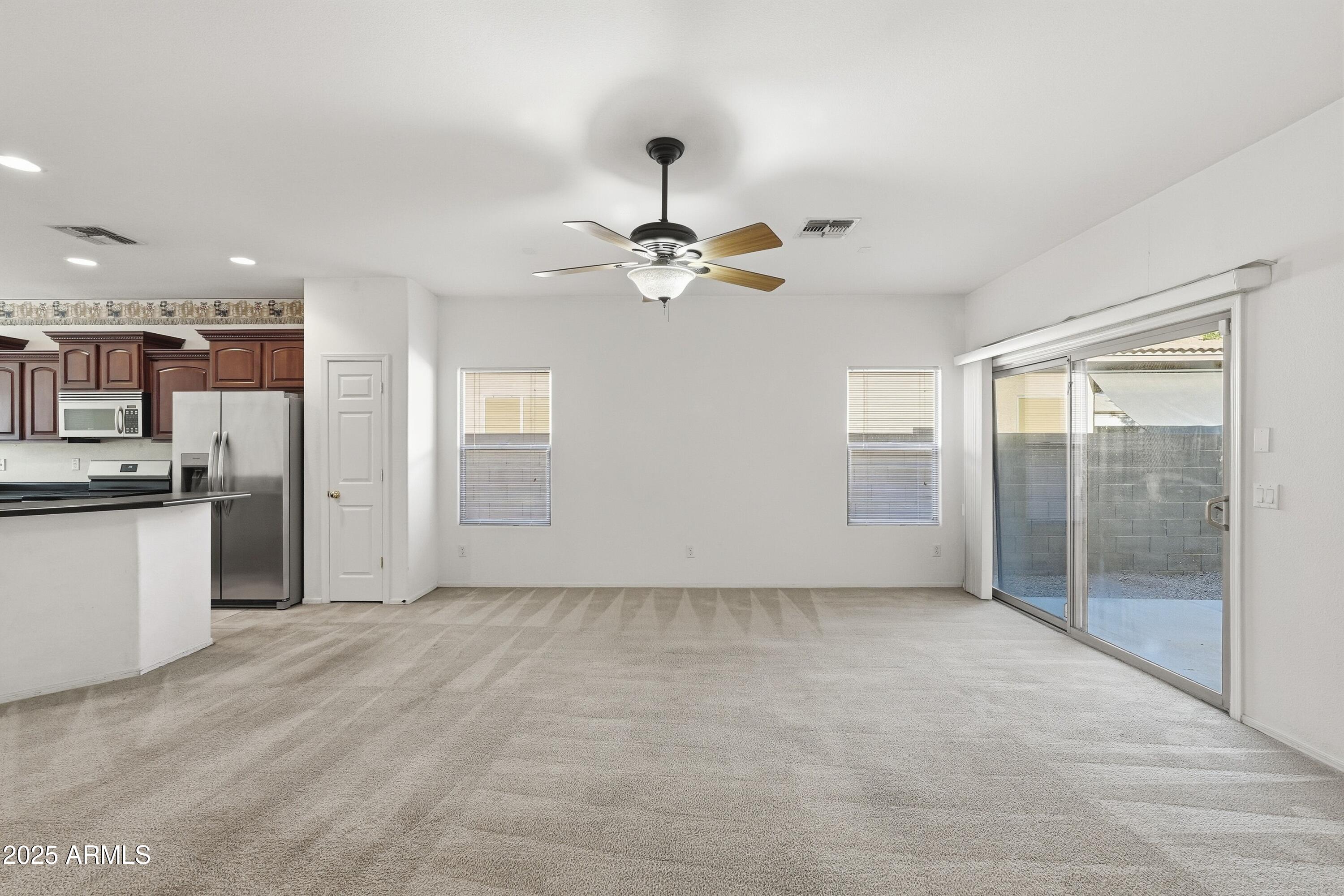 14568 West Crocus Drive Surprise, AZ 85379 - Photo 7 of 36 a view of an empty room with cabinet and a ceiling fan