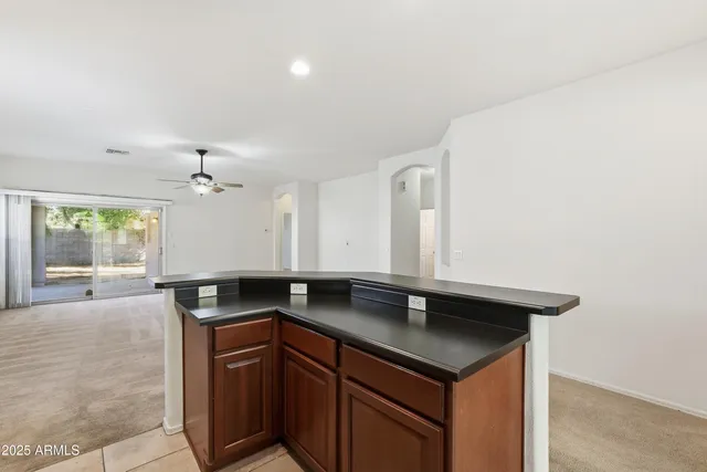 a kitchen with granite countertop a sink and cabinets
