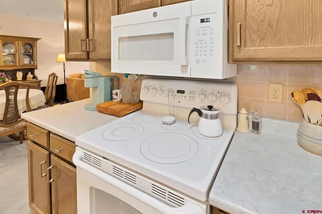 a kitchen with a sink a stove and cabinets