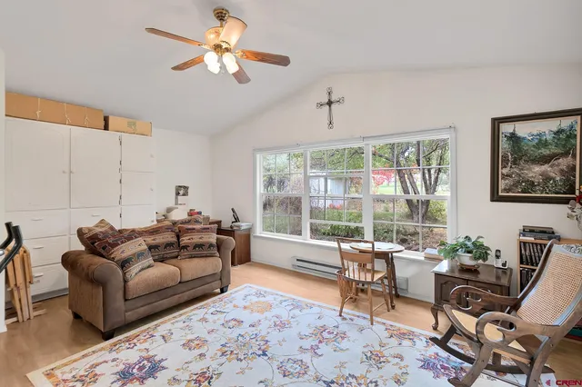 a living room with furniture a rug and white walls