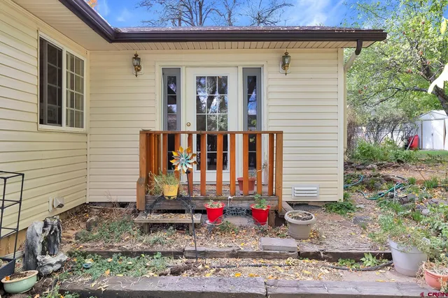 a backyard of a house with table and chairs