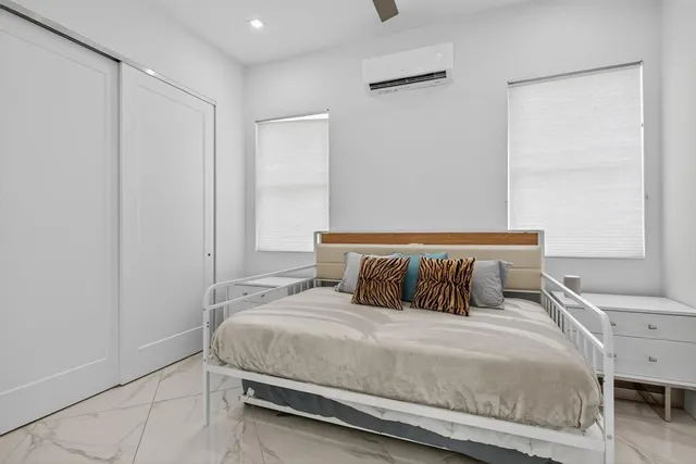 a bedroom with a bed and a window