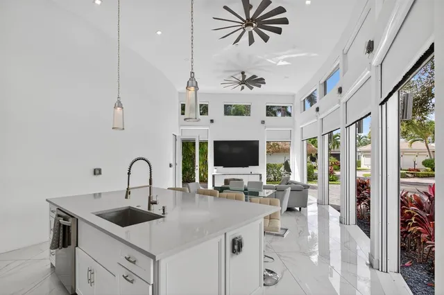 a kitchen with a stove a sink a dining table and chairs