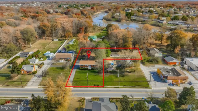 an aerial view of residential houses with outdoor space and swimming pool