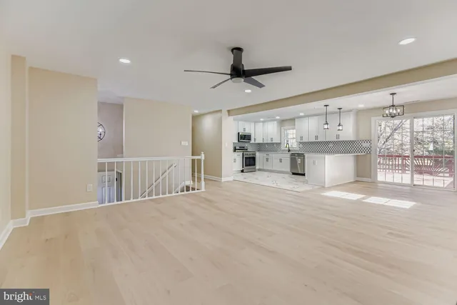 a view of a kitchen with a sink and a fireplace