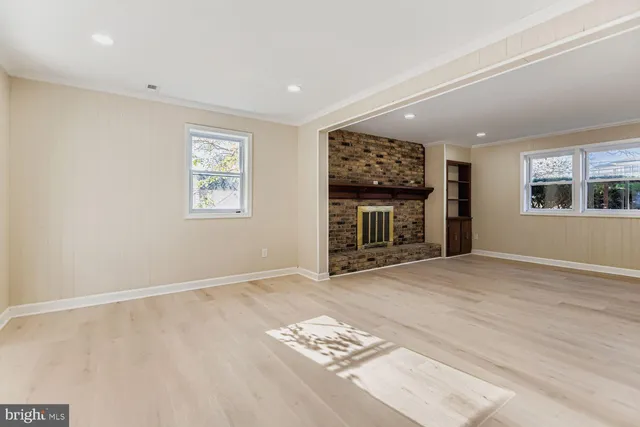 an empty room with windows and closet