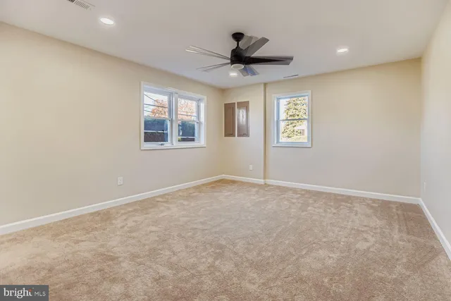 a bathroom with a toilet a sink a mirror a bathtub and vanity