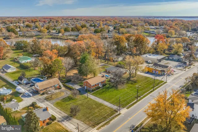 a view of a house with a yard balcony and large tree