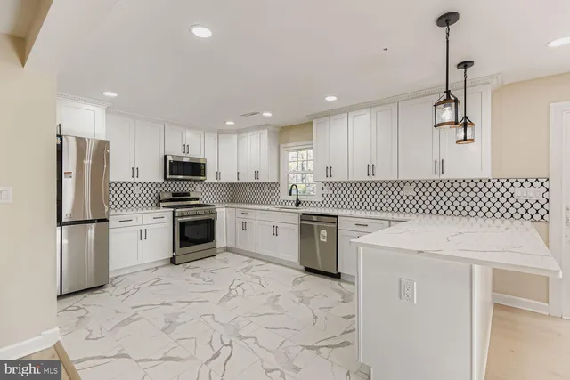 a kitchen that has a sink and a stove in it