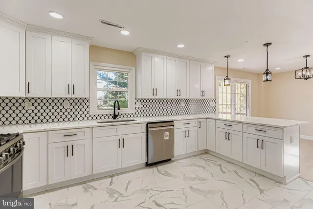 a kitchen with a refrigerator sink and stove