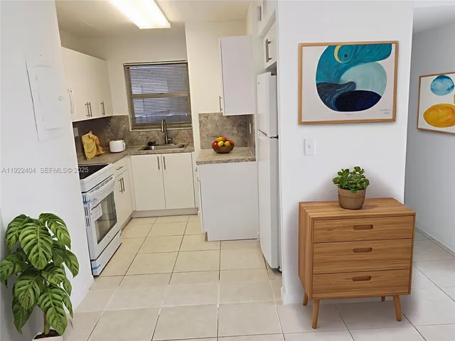 a kitchen with a refrigerator and a stove