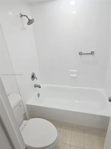 a bathroom with a toilet and shower