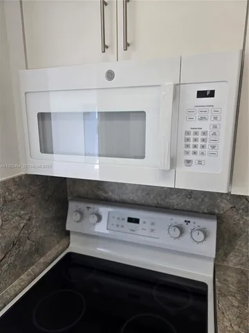 a stove top oven sitting inside of a kitchen