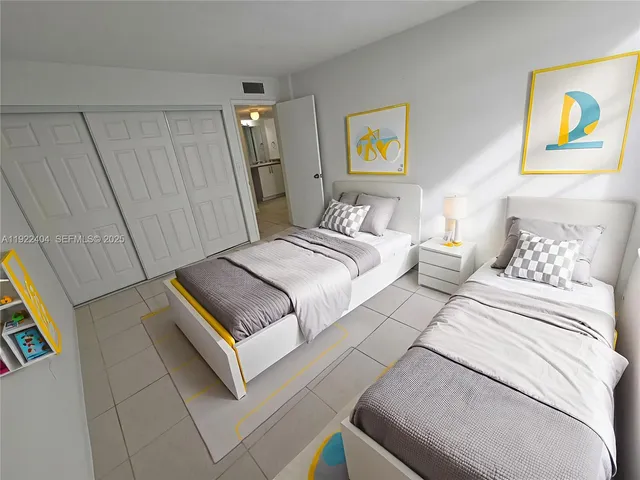 a bedroom with a bed and painting on the wall